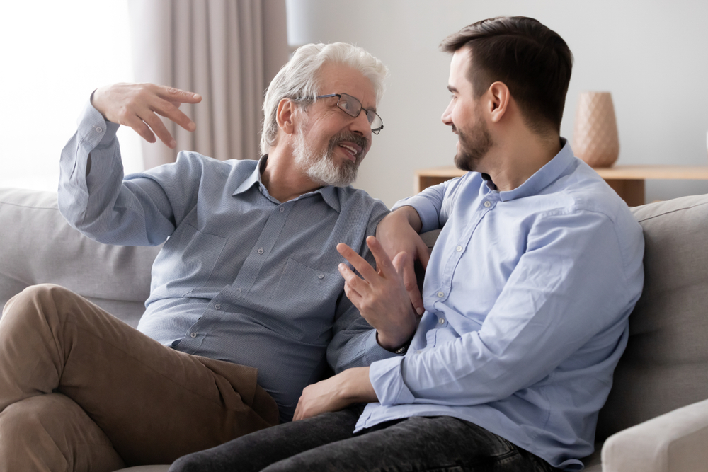 Father and Son Talking on Couch
